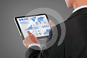 Man pushing on a touch screen tablet of infographics
