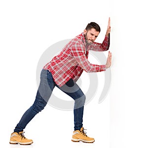 Man pushing a white wall