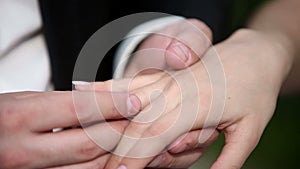 A man puts his woman a wedding ring on the finger. Close up macro