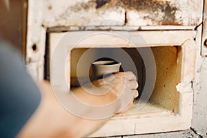 Man puts a jag in a clay oven