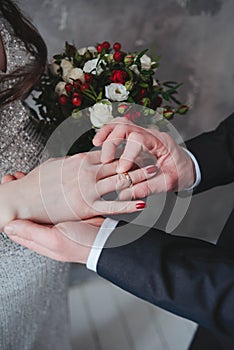 a man puts a ring on a woman's finger. Bride and groom