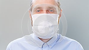 Man puts on and take off a gauze antivirus mask