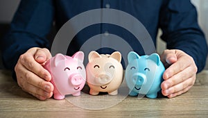 A man puts together piggy banks. Create your investment portfolio.