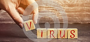 A man puts wooden blocks with the word virus. Covid-19. Coronavirus pandemic infection. Healthcare, medicine concept. Ncov photo