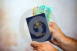 Man putting Australian money into passport