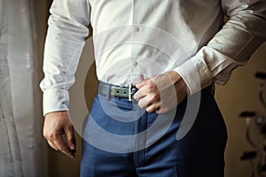 Man putting on a belt, Businessman, Politician, man`s style, mal