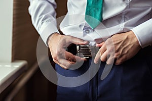 Man putting on a belt, Businessman, Politician, man`s style, mal