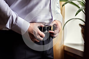 Man putting on a belt, Businessman, Politician, man`s style, mal