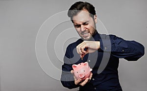 Man putting coin in piggy bank. Saving money concept