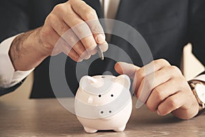 Man putting coin in piggy bank. saving money, finance concept.