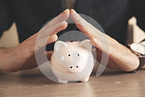 Man putting coin in piggy bank. saving money, finance concept,
