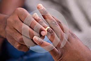 Man Putting An Engagement Ring On Woman`s Finger