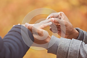 Man putting engagement silver ring on woman hand