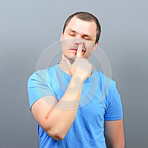 Man putting finger deep in his nose - Bad habit concept