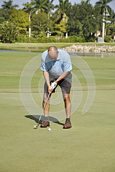 Man putting on a golf course