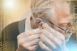 Man putting hearing aids; multiple exposure