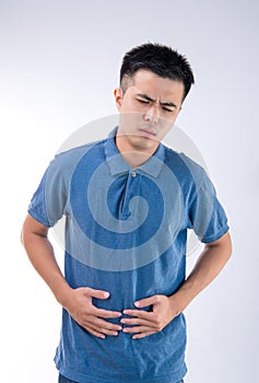 Man putting his hands for belly or stomach ache on white background