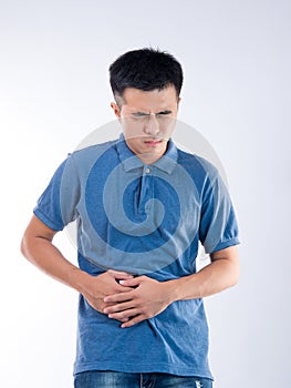 Man putting his hands for belly or stomach ache on white background