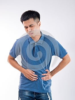 Man putting his hands for belly or stomach ache on white background