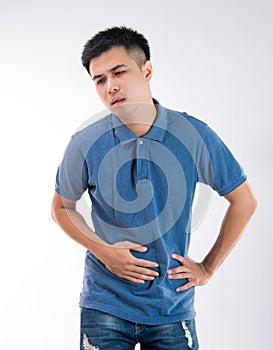 Man putting his hands for belly or stomach ache on white background