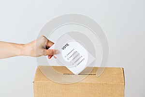 Man putting his vote into ballot box on election