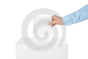 Man putting his vote into ballot box on white background