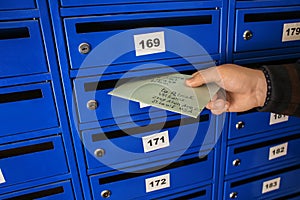 Man putting letter into mailbox