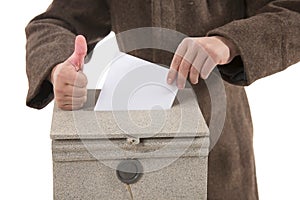 Man putting letter in mailbox,showing thumbs up gesture