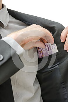 Man putting money in his pocket