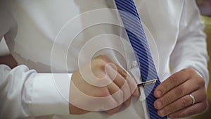 Man putting on neck tie