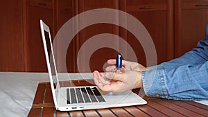 Man putting perfume on his hands on an online date.