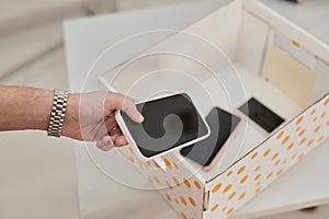 Man putting phone in box