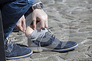 Man putting plaster on blister