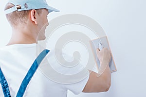 Man putting plaster on wall