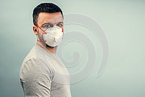 A man is putting on a protective mask. Respiratory protection from coronavirus. Personal protective equipment for a