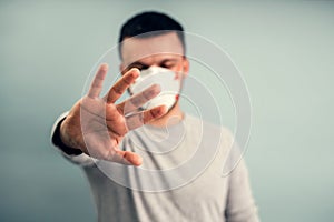 A man is putting on a protective mask. Respiratory protection from coronavirus. Personal protective equipment for a