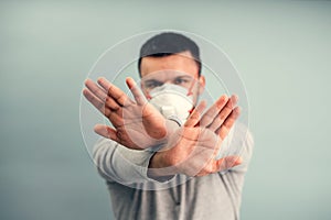 A man is putting on a protective mask. Respiratory protection from coronavirus. Personal protective equipment for a