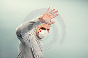 A man is putting on a protective mask. Respiratory protection from coronavirus. Personal protective equipment for a