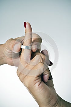 Man putting on or putting off a ring from the finger of a woman photo