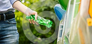 Man putting twisted bottle into trash can.