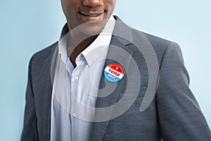 Man putting on Vote button for Presidential election 2020
