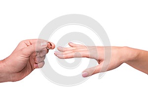 Man putting a wedding ring on her finger