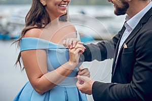 Man putting wedding ring on womans finger