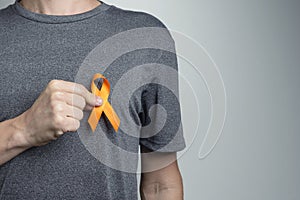 Man putting white ribbon on his shirt. Awareness symbol