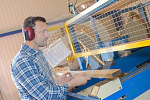 Man putting wood into machine