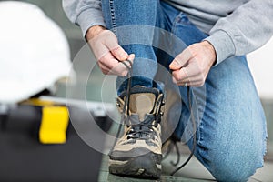 man putting workboots on