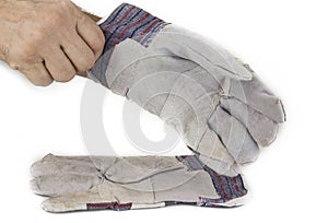 Man putting on a working gloves on white.