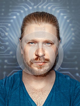 Man With QR Code On Forehead On Background Of Fluorescent Chip, front view portrait