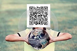 a man with a qr code on his face is holding the planet in his hands. Constraints concept. Image element used by NASA