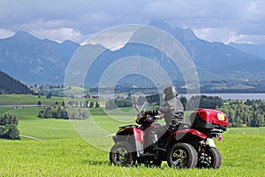 A man on quad before the mountains in Bavaria